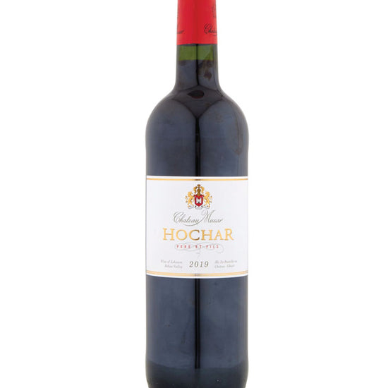 A bottle of Chateau Musar Hochar Père et Fils 2019 red wine. The bottle has a red foil capsule and a white label with gold and black text. The label features a crest at the top, the name 'Chateau Musar' in cursive, 'HOCHAR' in bold gold letters, and 'Père et Fils' beneath in red. The wine is from the Bekaa Valley in Lebanon.