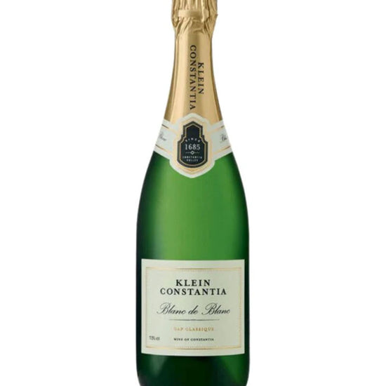 Green champagne bottle with gold foil cap on a white background
