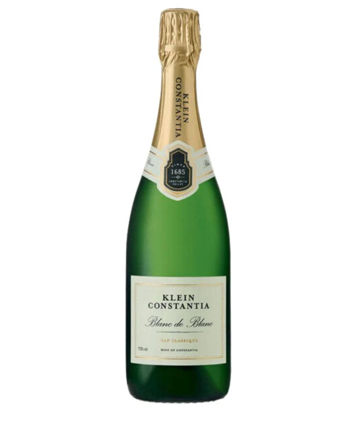 Green champagne bottle with gold foil cap on a white background