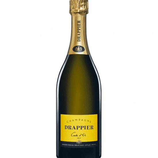 A bottle of Drappier Creme d'Or Champagne, featuring a dark brown glass bottle, a gold foil neck wrap, and a prominent gold label on the front.