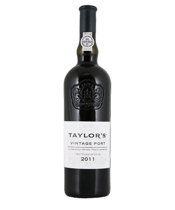 A bottle of Taylor's Vintage Port 2011 wine, featuring a dark glass bottle with a black capsule and a white label, set against a plain white background.